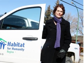Kelly Holmes-Binns, new CEO of Habitat for Humanity in front of Habitat Plains in Regina in 2014.