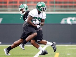 Kevin Glenn (back) hands off to Jerome Messam during a Riders practice (MICHAEL BELL/Leader-Post)