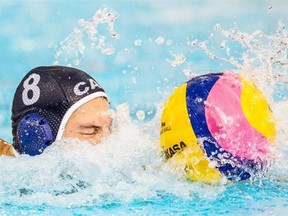 Kevin Graham of Canada swims with the ball against the USA during the men’s water polo semifinal match at the Pan Am Games in Markham, Ont., Monday July 13, 2015.