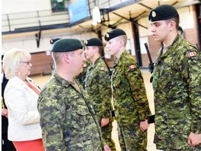 Lieutenant Colonel Victor Sattler and Lt.-Gov. Vaughn Solomon inspect graduates from the high school military training course in Regina June 11, 2015.