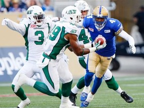 Linebacker Jeff Knox Jr., shown making an interception Saturday, was a key part of a strong Saskatchewan Roughriders defence against the host Winnipeg Blue Bombers (John Woods/The Canadian Press)