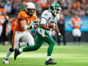 B.C. Lions’ Alex Hoffman-Ellis, left, chases down Saskatchewan Roughriders’ quarterback Kevin Glenn during the first half of a CFL football game in Vancouver, B.C., on Saturday October 3, 2015.