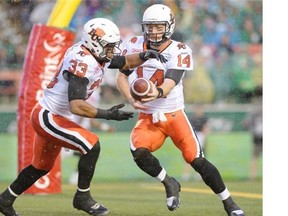 BC Lions running back Andrew Harris (#33) takes the hand off from BC Lions quarterback Travis Lulay (#14)  during first half CFL action at Mosaic Stadium in Regina on Friday.
