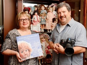 Lisa Healy, left, poses with her husband Don Healy, right, at their home in Regina, Sask. on Saturday Aug. 15, 2015. Lisa Healy self-published a book about Canadian dolls based on her collection. Don provided the photographs featured in the book. (Michael Bell/Regina Leader-Post)