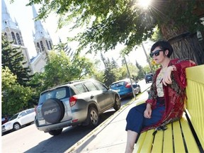 Lisa Wicklund sits on the colourful bench she painted outside of her store, Seed Sustainable Style, in Regina on July 30, 2015. Area business owners wish there was more of a collective effort among them and through the city, to beautify the area and draw visitors.