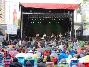 A little sprinkling of rain didn’t dampen the spirits of those enjoying the opening night of the Regina Folk Festival in Victoria Park on Friday. (TROY FLEECE / Regina Leader-Post)