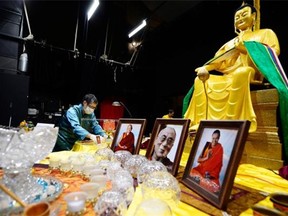 Martha Cabral, tour manager with The Maitreya Loving Kindness Tour, sets up historical Buddhist relics at Darke Hall in Regina on Friday.