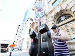 Matt Braun plugs a parking meter on the 2000 block of 11th Avenue in Regina on Tuesday. (DON HEALY/Leader-Post)