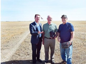 Mayor Michael Fougere (L), director of Pacers Baseball Jim Fink (C), and president Tony Kuffner (R) stand in a field that will be the new Pacer Park off Tower Road on Sept. 11, 2015.  (DON HEALY/Regina Leader-Post)