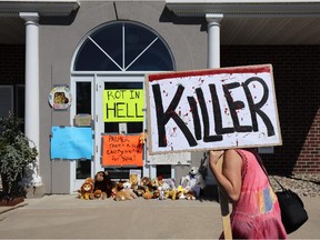 Protesters call attention to the alleged poaching of Cecil the lion, in the parking lot of Dr. Walter Palmer's River Bluff Dental Clinic on July 29, 2015 in Bloomington, Minnesota.