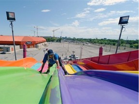 Michael Bourgeois, labourer with North American Midway, works on setting up the Euro Slide for the upcoming Queen City Ex in Regina on Sunday.
