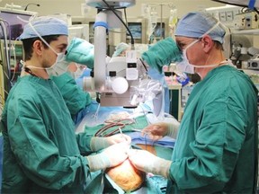 Dr. Michael Klebuc (right) was the leader of a surgical team that performed the world’s first skull and scalp transplant in a Houston Hospital last month. (Provided)