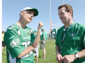 Mike Cordoba, CEO of Mr. Mikes Steakhouse Casual speaks with Regina mayor Michael Fougere at Mikes Unite at Mosaic Stadium in Regina on Saturday June 27, 2015. The fundraiser for KidSport attempted to break the world record of a gathering of people with the same first name.