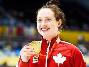 Morgan Bird of Canada shows off her gold medal after winning the women's S8 400m and the women's S8 50m during the Parapan Am Games in Toronto on Sunday, August 9, 2015. THE CANADIAN PRESS/Nathan Denette