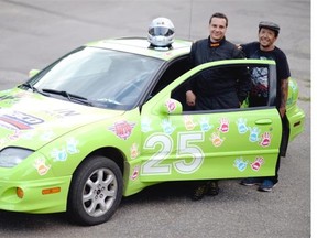 Noel McAvena, left, driver, and Clint Tucker, car owner, stand beside the mini-stock car in Regina on Thursday.