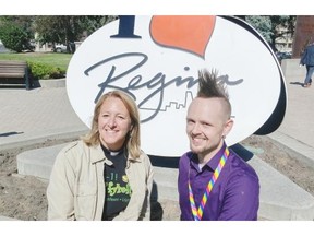 Pastor Carla Blakley (left) and organizer Phil Ollenberg sit outside Regina City Hall where a pride flag was raised to commence the 26th Queen City Pride Festival running June 15 to 21.