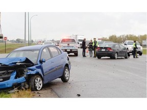 Photos of the scene of a two vehicle crash on the Trans-Canada Highway at Tower Road that had eastbound traffic backed up leaving Regina Sept. 17, 2015.
