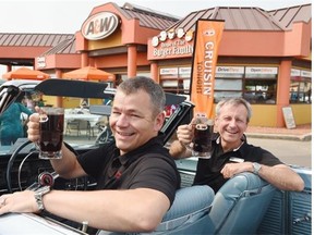 President & CEO of the MS Society, Yves Savoie, left, and A&W CEO Paul Hollands toast A&W’s Cruisin’ to end MS event with A&W root beer at the A&W in the Avon Shopping Centre in Regina on August 27, 2015. They are sitting in a 1966 plymouth satellite convertible owned by Lawrence & Gladys Ireland.  DON HEALY/Regina Leader-Post