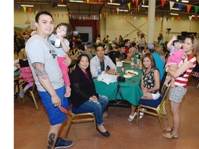 Quiel Apuada (far left) with family and friends at the Philippine pavilion during the multicultural festival Mosaic in Regina on Saturday June 6, 2015.