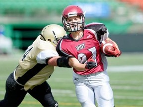 Rachelle Smith, 81, of the Regina Riot eludes Darla Caligiuri, left, of the Manitoba Fearless during Sunday's game at Mosaic Stadium.