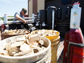 Cal Rader fiddles with switches of his homemade wood-powered truck on his farm outside Mortlach, Sask. on July 21, 2015.