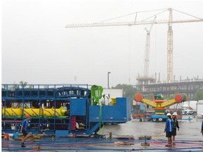 Rain falls in Regina as workers continue to set up for the Queen City Ex.