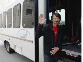 Randy Belanger, a bus driver from Ile-a-la-Crosse, waves as he boards a bus at the University of Regina on Sunday July 5, 2015. Belanger and other members of the community were allowed to return to Ile-a-la-Crosse. (Michael Bell/Regina Leader-Post)