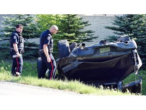 Regina city police members investigate a single vehicle accident on McCarthy Boulevard., just north of Lakeridge Road where a Dodge Ram pickup left the road and smashed into a neighbourhood perimeter wall in Regina on August 10, 2015.