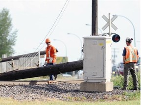 The Regina Fire department, CN people as well as Police and SaskPower were on the scene of three power poles that fell on Winnipeg St. near 5th Avenue North Wednesday afternoon.