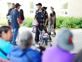 REGINA, SK :  July 14, 2015  --  Mike Montgrand and his 18-month-old son Mikey Herman, of La Loche, are among the evacuees outside the EventPlex in Regina on Tuesday. 
 TROY FLEECE / Regina Leader-Post