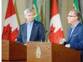 Prime Minister Stephen Harper, left, and Saskatchewan Premier Brad Wall hold a news conference at the Legislative Building in Regina on Friday.