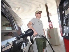 Jeff More of Regina fills up with gas at the Petro-Can on South Albert Street in Regina June 11, 2015 for 117.9 cents a litre.