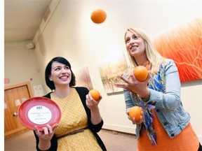 Jess Richter (L) and Haley Gartner, both with the Art Gallery of Regina, get in the spirit of Orange, which is a fundraiser for the Art Gallery of Regina.