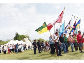 Lyle Daniels (R) leads the The Grand Entry with an Eagle staff for National Aboriginal Day Celebrations at Grassick Playground in Regina on June 19, 2015.