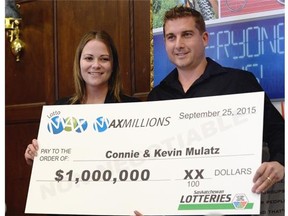 Connie and Kevin Mulatz pick up their $1-million cheque for winning the Sept. 25 Lotto Max draw at a news conference in Regina on Thursday.