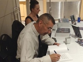 REGINA SK: October 20, 2015 — Ernie Louttit signing copies of his book at the Delta Hotel in Regina on Tuesday. (KERRY BENJOE/Regina Leader-Post)