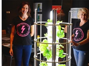 Margot Klein, left, and Laurie Petroski stand beside The Tower Garden  during the The Ignite! Festival at the Saskatchewan Science Centre in Regina on Friday.  The  festival is dedicated to inventions and creating interesting things.