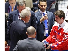 Regina Pats defenceman Connor Hobbs, right, is welcomed to the Washington Capitals' organization at the NHL draft on Saturday in Sunrise, Fla. 
  
 Alan Diaz/Associated Press