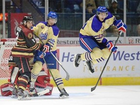 Regina Pats forward Lane Zablocki (#39) jumps over a shot on the Moose Jaw Warriors goal during a game held at the Brandt Centre in Regina, Sask. on Saturday Sep. 26, 2015. (Michael Bell/Regina Leader-Post)