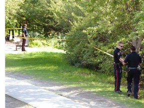 Police cordoned off an area of shoreline at Wascana lake as a person walking through the park spotted a body on the shore in Regina August 10, 2015.