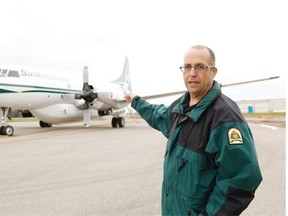 Steve Roberts, executive director of wildfire management for Saskatchewan, speaks at an announcement of new international firefighting agreements on Monday, Sept. 14, 2015 in Regina. Pictured also is a Convair 580A tanker aircraft.