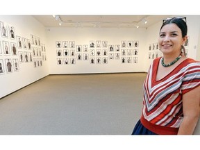 Photos of curator Michelle LaVallee standing in the (Re)facing the Camera exhibition of black-and-white portraits by Rosalie Favell, showcasing the indigenous creative community (artists, curators, etc.) on Sept. 1 2015.