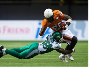 Riders defensive back Tristan Jackson, shown tackling the B.C. Lions’ Shawn Gore on Friday, responded Tuesday to criticism from members of the Lions organization (Darryl Dyck/The Canadian Press files)