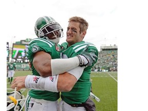 Riders quarterback Brett Smith (16) congratulates linebacker Tyron Brackenridge (41) on his touchdown during Sunday’s Labour Day Classic (Michael Bell/Regina Leader-Post)