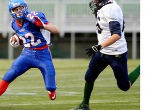 Riffel’s Kyle Borsa 22 makes a cut on Knoll’s Brandon Mason 66 during high School football action between Riffel and Knoll in Regina October 23, 2014.