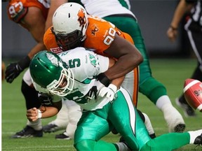 Roughriders quarterback Kevin Glenn (5) fumbles the ball while being tackled by B.C. Lions’ Jabar Westerman on Saturday (Darryl Dyck/The Canadian Press)