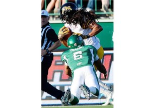 Roughriders quarterback Kevin Glenn, 5, left Sunday's game due to injury after making this tackle on Hamilton's Rico Murray following an interception on the final play of the third quarter. 
  
 Troy Fleece/Leader-Post