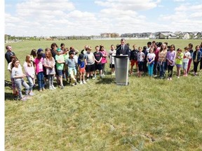 Saskatchewan Education Minister Don Morgan talks about the building of three new joint-use schools at the corner of Ambulet Drive and James Hill Road in Regina on June 15, 2015.