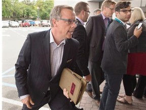 Saskatchewan Premier Brad Wall heads from a scrum with reporters at the summer meeting of Canada's premiers in St. John's on Thursday, July 16, 2015. THE CANADIAN PRESS/Andrew Vaughan