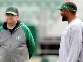 Saskatchewan Roughrider general manager Brendan Taman (left) and head coach Cory Chamblin chat during Rider practice at Mosaic Stadium in Regina Friday August 28, 2015.